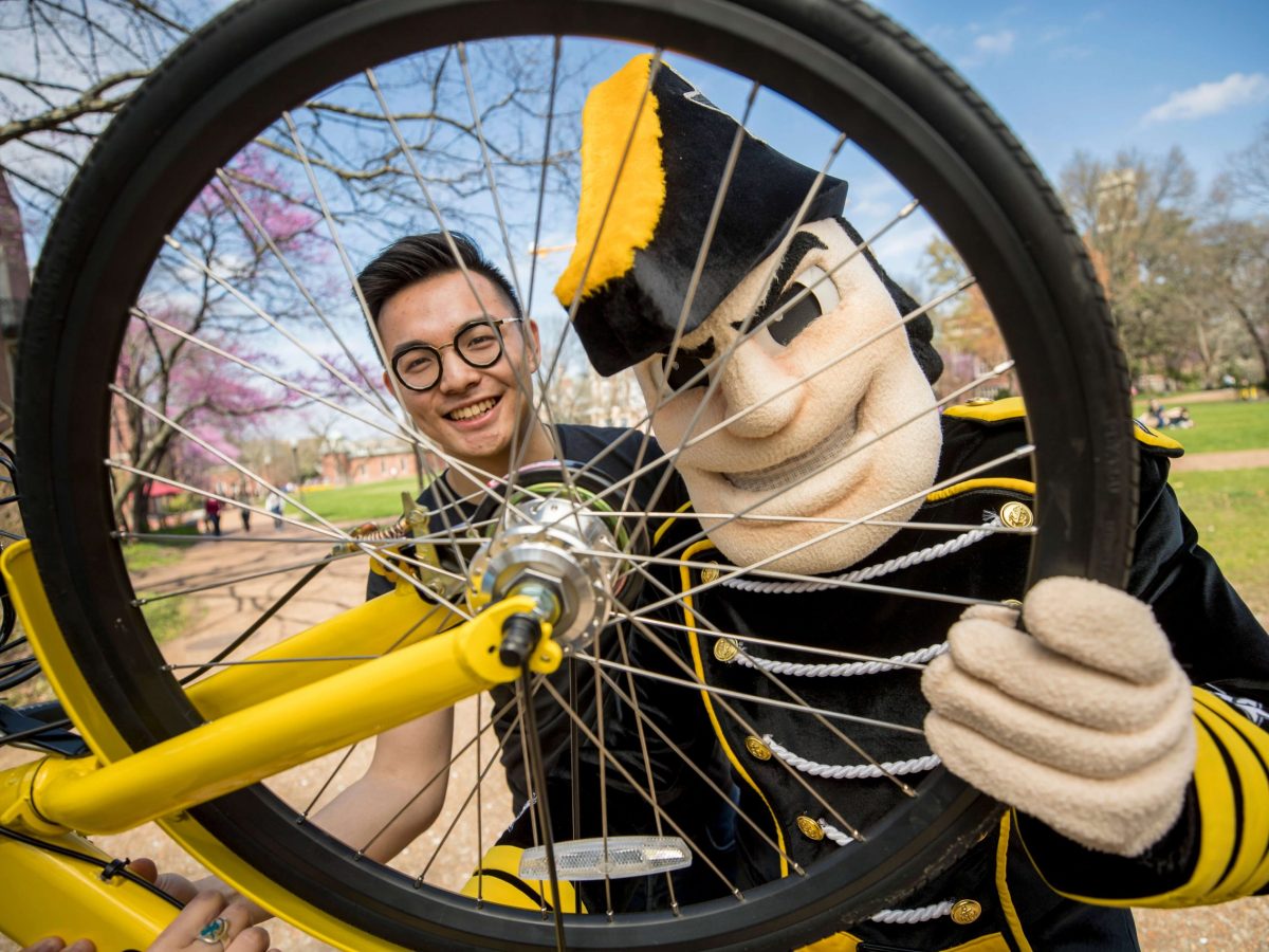 Two guys looking through wheel 