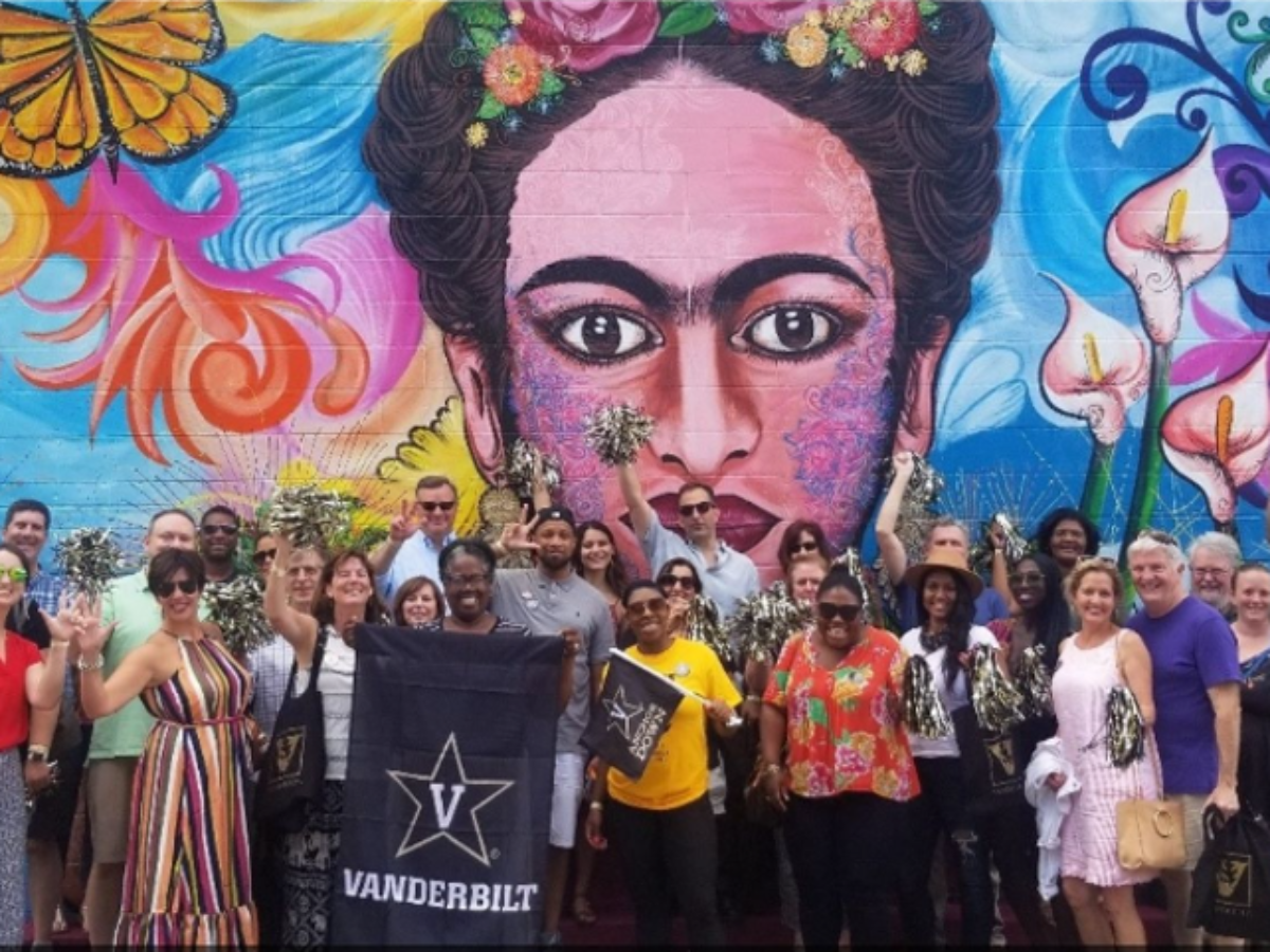 Group photo in front of a Frida Kahlo mural in Nashville
