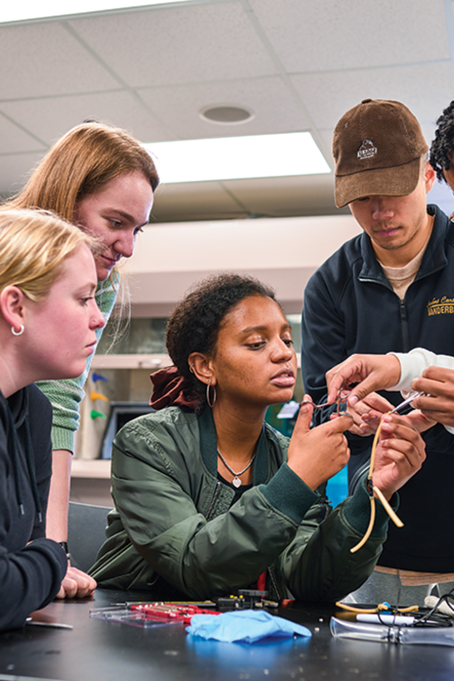 five students working together in a laboratory