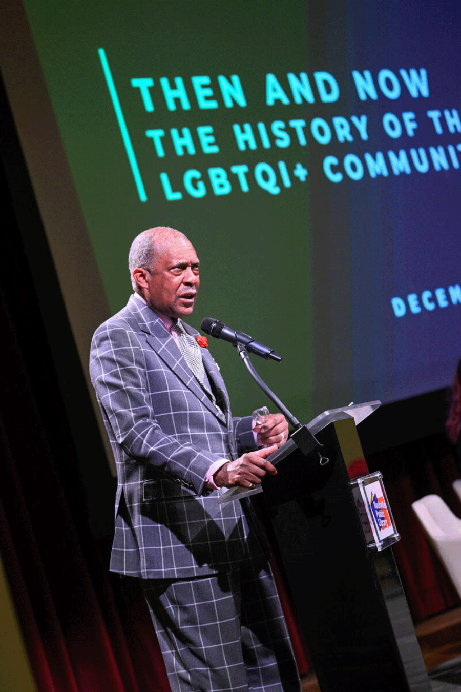 Dr. André L. Churchwell on stage addressing a crowd at the Nashville Public Library